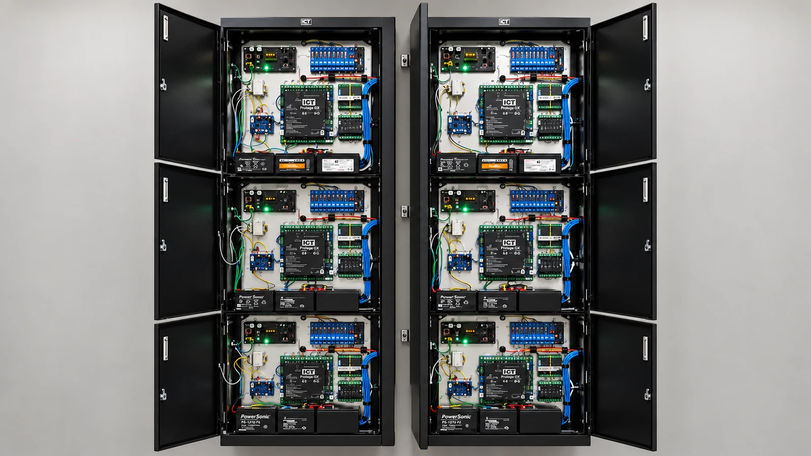 Six open access control panels with circuit boards, backup batteries, and organized wiring.